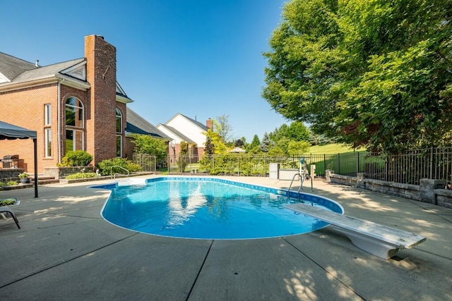 view of swimming pool with a patio area, a fenced in pool, and fence