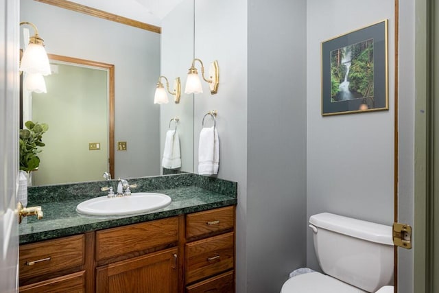 bathroom featuring toilet and vanity