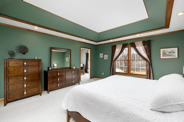 carpeted bedroom featuring a tray ceiling, recessed lighting, baseboards, and ornamental molding