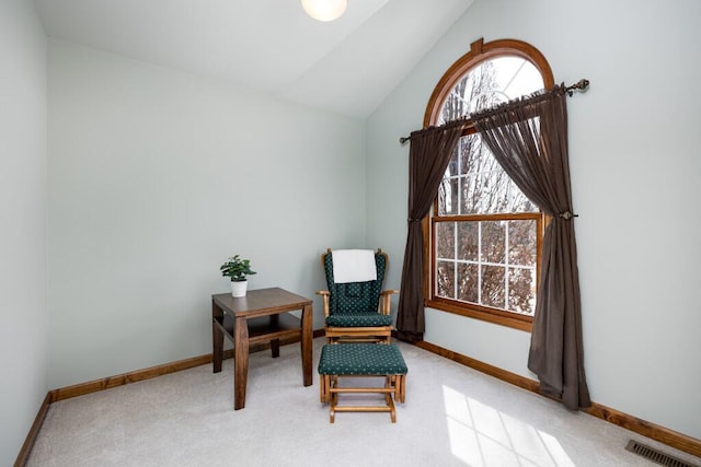 living area featuring vaulted ceiling, baseboards, visible vents, and carpet floors