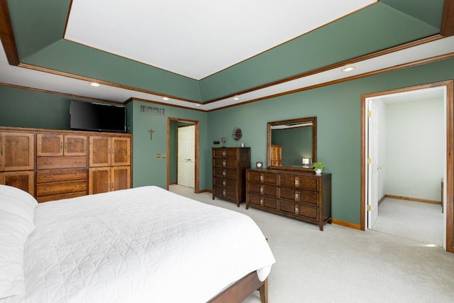 bedroom with visible vents, a tray ceiling, carpet flooring, crown molding, and baseboards