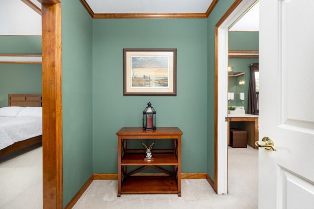 hall featuring carpet flooring, crown molding, and baseboards