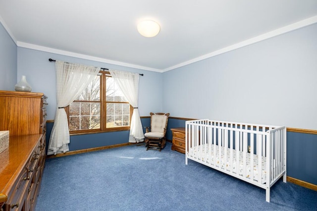 bedroom featuring a nursery area, carpet, crown molding, and baseboards