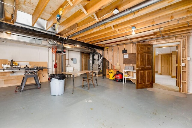 unfinished basement featuring heating unit