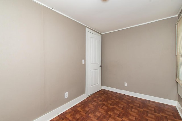 spare room featuring baseboards and ornamental molding