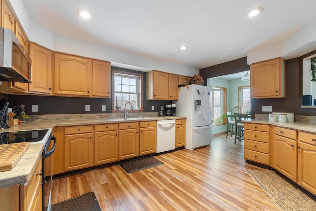 kitchen with recessed lighting, white appliances, light wood-style floors, and light countertops