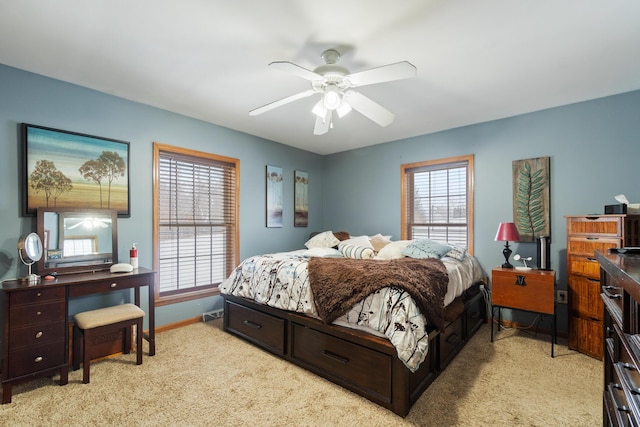 bedroom featuring ceiling fan, light colored carpet, and baseboards