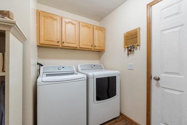 laundry room with cabinet space, baseboards, and separate washer and dryer