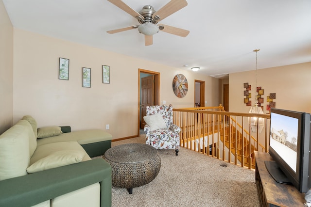 living area featuring baseboards and carpet floors