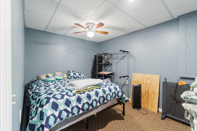 bedroom with carpet, a paneled ceiling, and ceiling fan