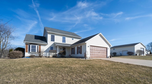 traditional-style house with a garage, driveway, and a front yard