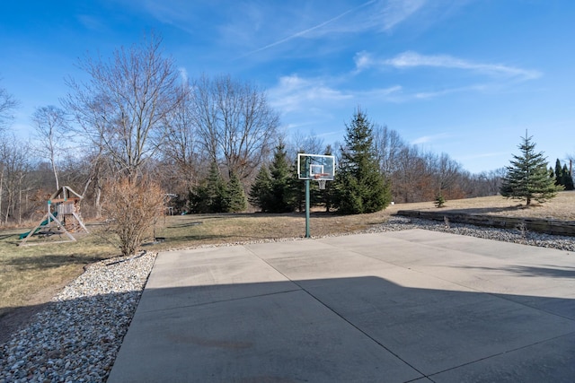 view of patio with basketball court and a playground