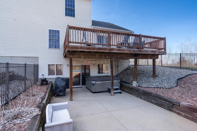 view of patio / terrace with a deck, grilling area, a fenced backyard, and a hot tub