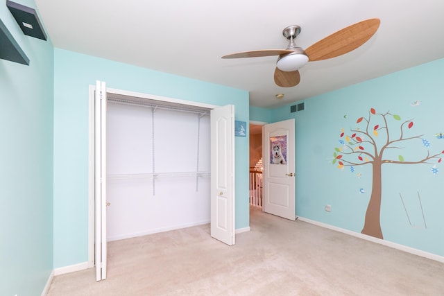 unfurnished bedroom with a closet, visible vents, light colored carpet, and baseboards