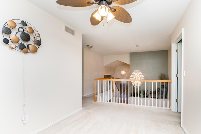 spare room featuring visible vents, baseboards, a notable chandelier, and carpet flooring