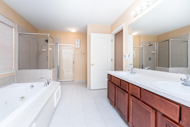 full bathroom with a sink, a jetted tub, a shower stall, and tile patterned flooring