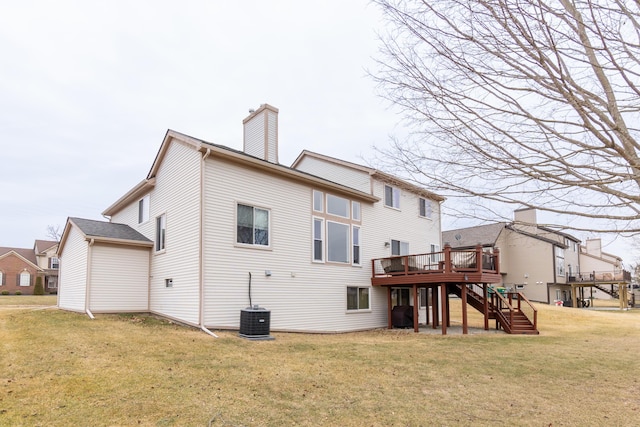 back of property featuring stairway, a wooden deck, a chimney, central air condition unit, and a lawn