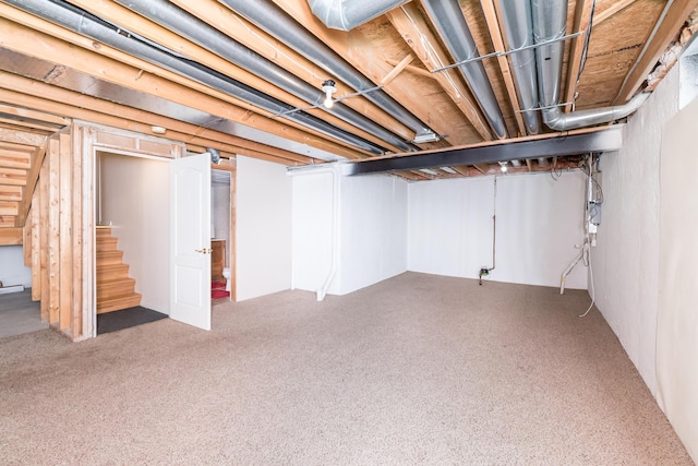 finished basement with stairs and carpet floors