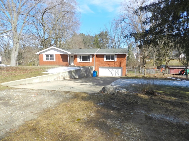 exterior space with a garage, brick siding, and driveway