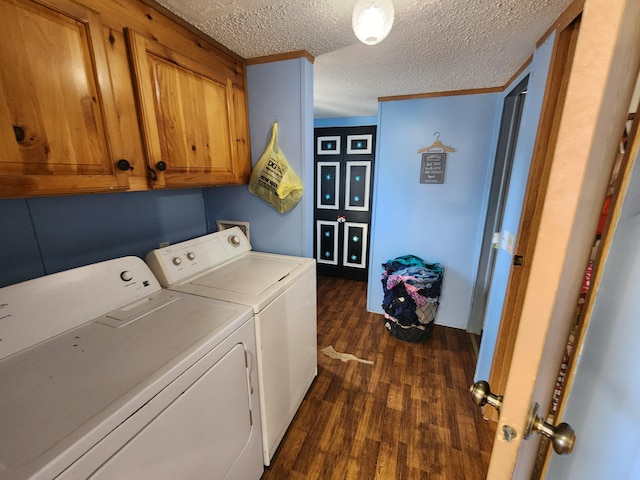 laundry room with washer and dryer, cabinet space, a textured ceiling, and dark wood finished floors