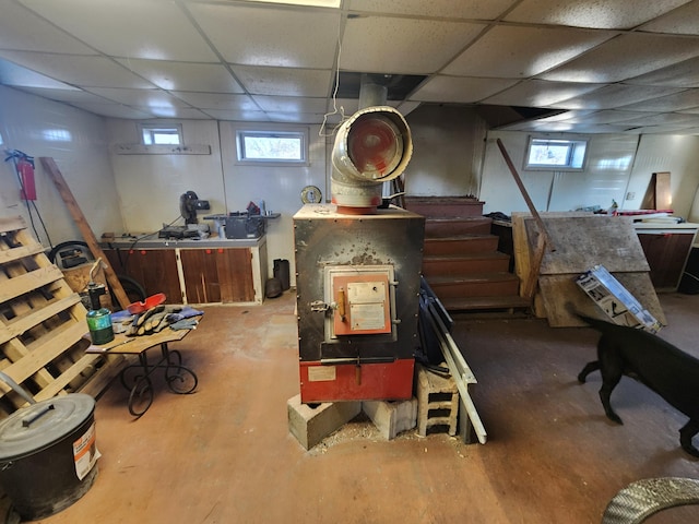 basement featuring stairway and a paneled ceiling