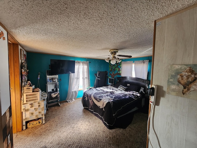bedroom with a textured ceiling, carpet, and a ceiling fan
