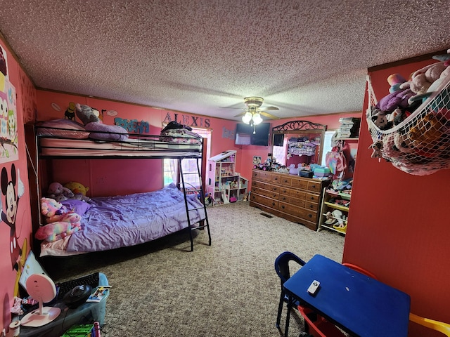 bedroom featuring ceiling fan, carpet, and a textured ceiling