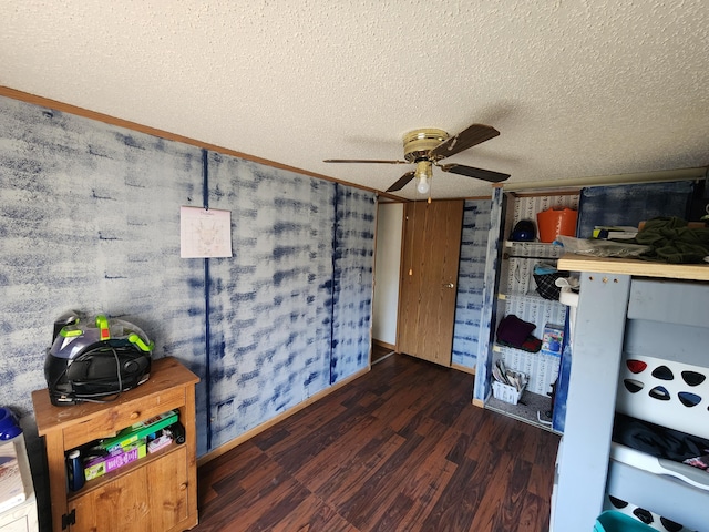 bedroom featuring a textured ceiling, ceiling fan, and wood finished floors