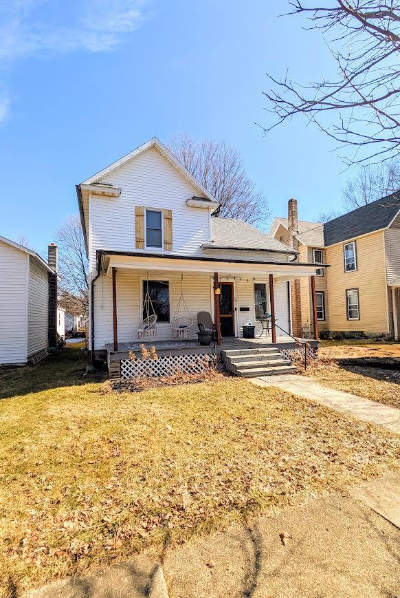 view of front of home with a porch and a front yard