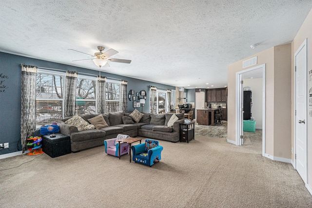 living area featuring visible vents, plenty of natural light, light colored carpet, and baseboards