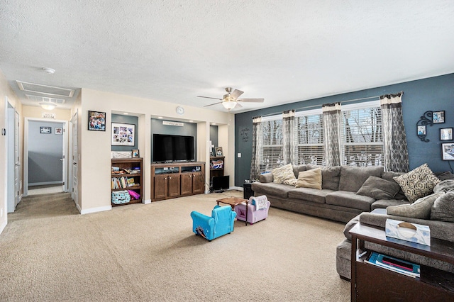 carpeted living area featuring baseboards, a textured ceiling, and ceiling fan