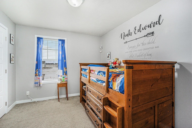 bedroom featuring light colored carpet and baseboards