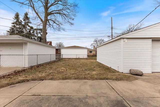 view of yard with an outbuilding and fence