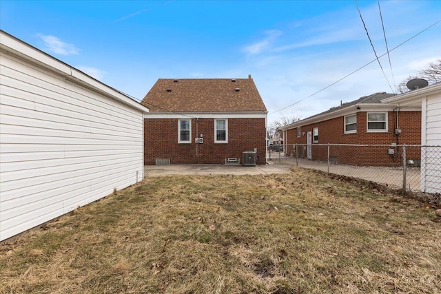 rear view of property featuring central air condition unit, a yard, a fenced backyard, and a patio area