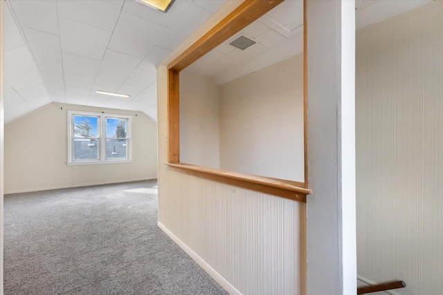 additional living space featuring carpet and vaulted ceiling