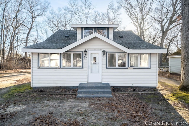 bungalow-style house featuring entry steps and a shingled roof