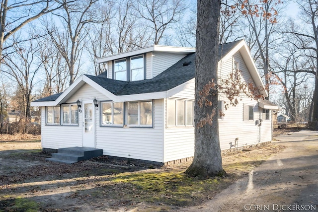 bungalow-style house featuring a shingled roof