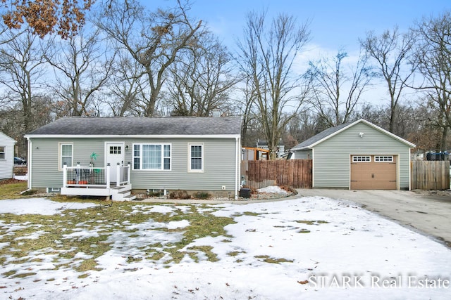 ranch-style house featuring an outdoor structure, fence, driveway, and a detached garage