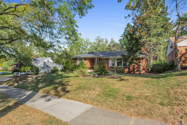 single story home with a front yard and brick siding