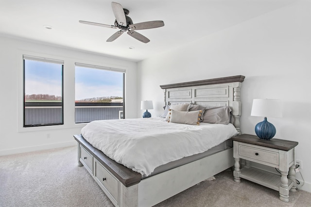 carpeted bedroom with baseboards and ceiling fan