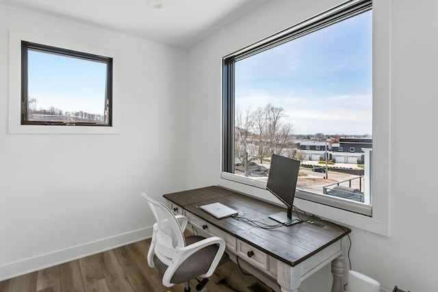 home office featuring wood finished floors and baseboards