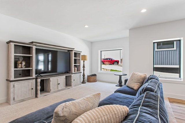 living area featuring recessed lighting and baseboards