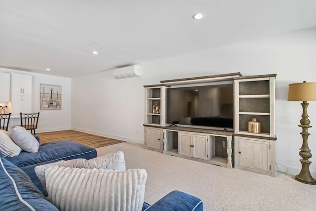 living room with a wall unit AC, wood finished floors, recessed lighting, and baseboards