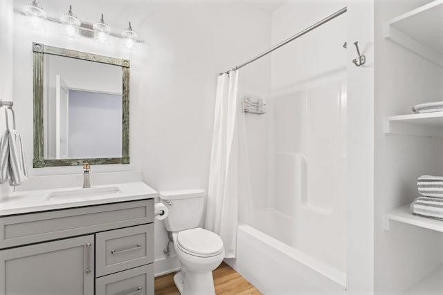 bathroom with shower / bath combination with curtain, toilet, vanity, and wood finished floors