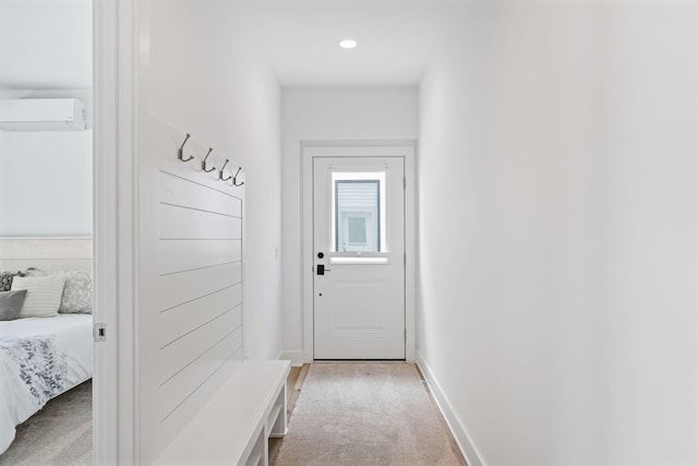 mudroom with light carpet, recessed lighting, a wall mounted AC, and baseboards