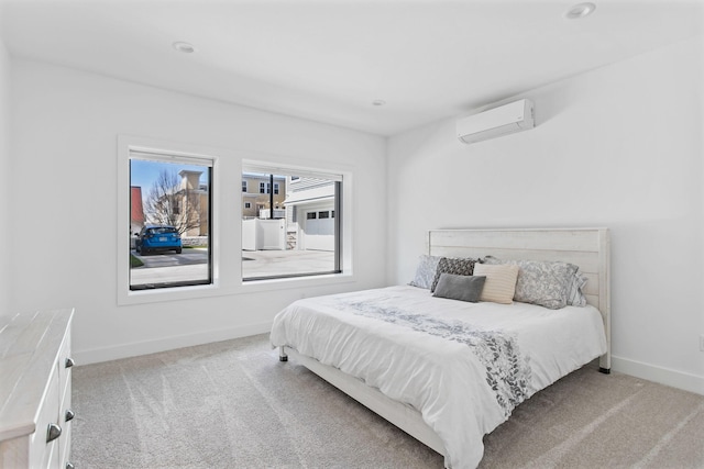 carpeted bedroom with baseboards and a wall unit AC