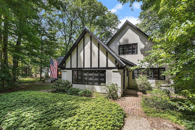 english style home with stucco siding