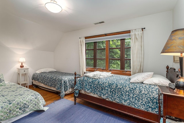 14598 Lakeshore Rd, Lakeside, MI 49116 - bedroom with vaulted ceiling, visible vents, and wood finished floors