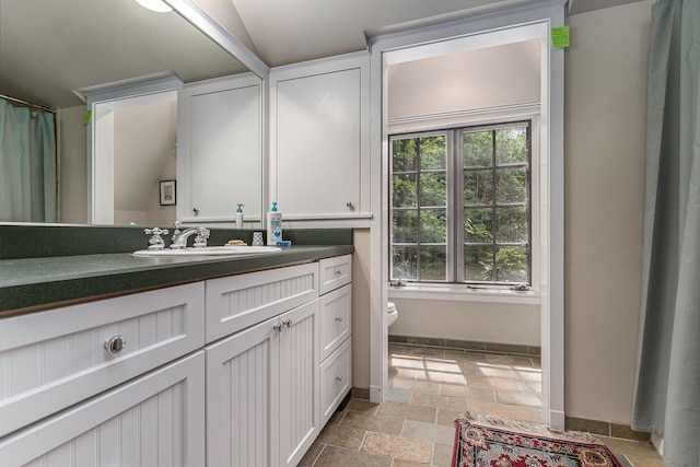 14598 Lakeshore Rd, Lakeside, MI 49116 - bathroom featuring baseboards, toilet, stone tile flooring, and vanity