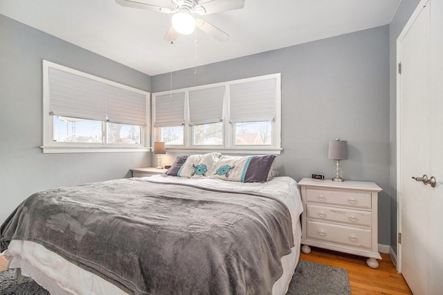 bedroom with light wood finished floors and a ceiling fan